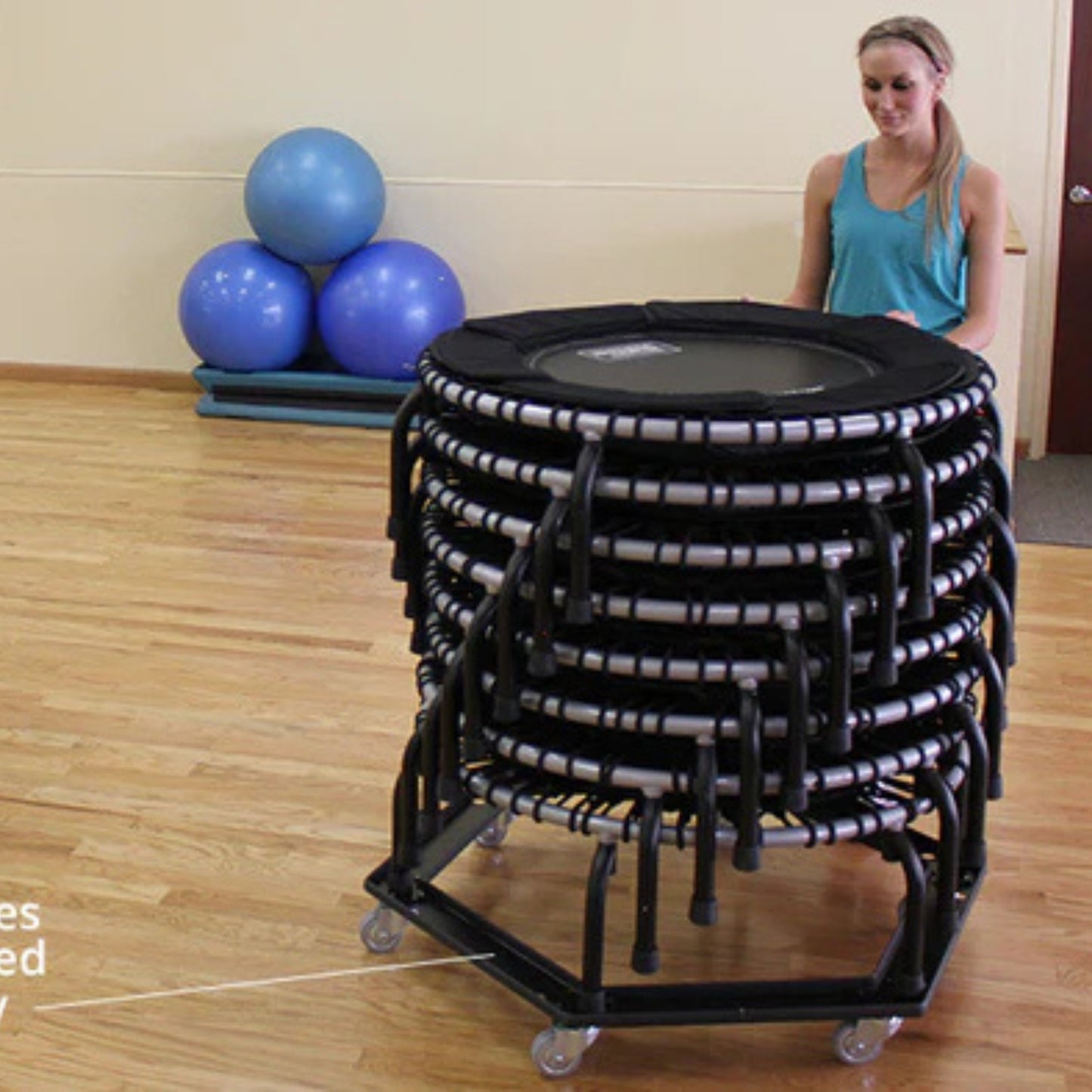 Jumpsport trampoline storage cart stacked with rebounders in group fitness room