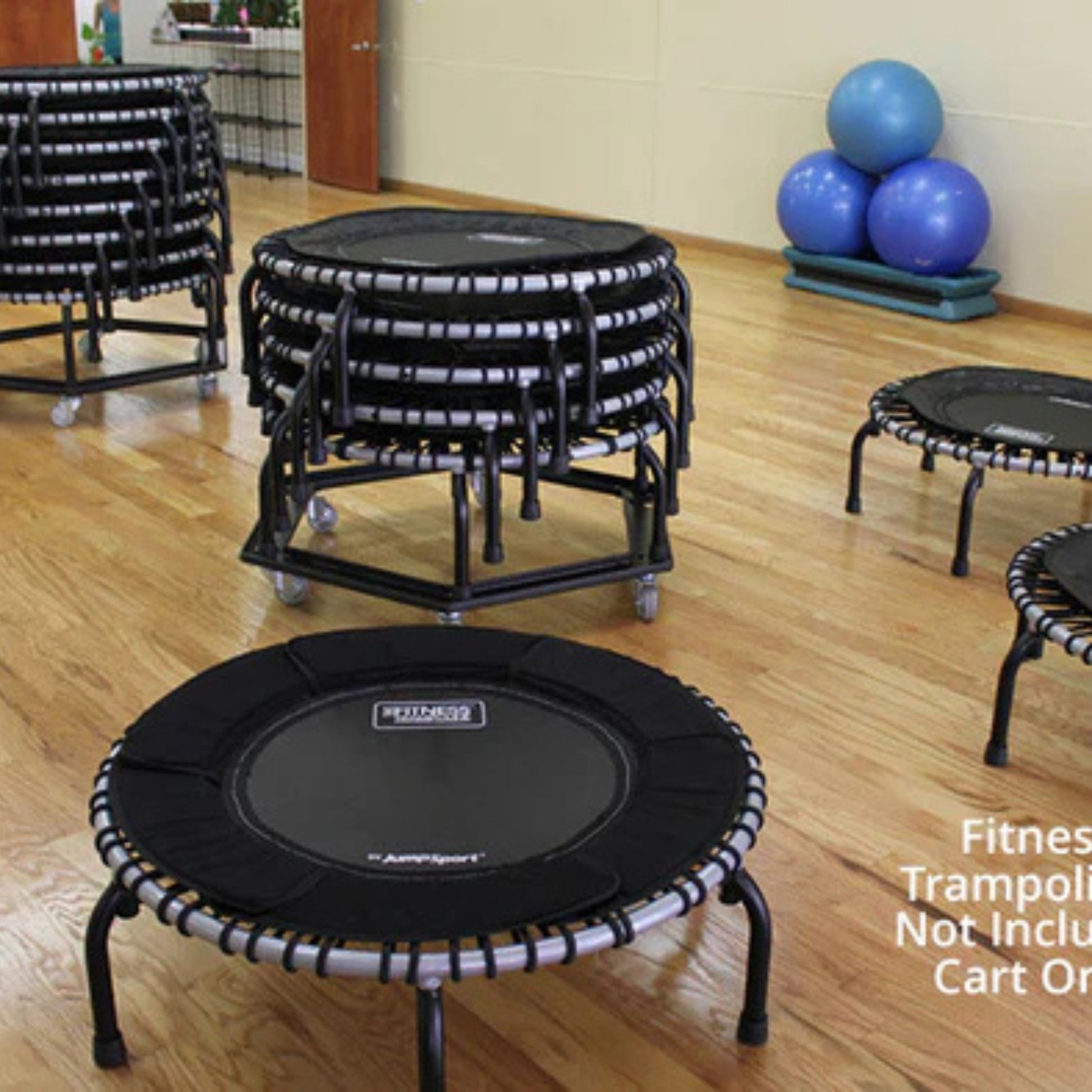 Jumpsport trampoline storage cart stacked with rebounders in gym setting