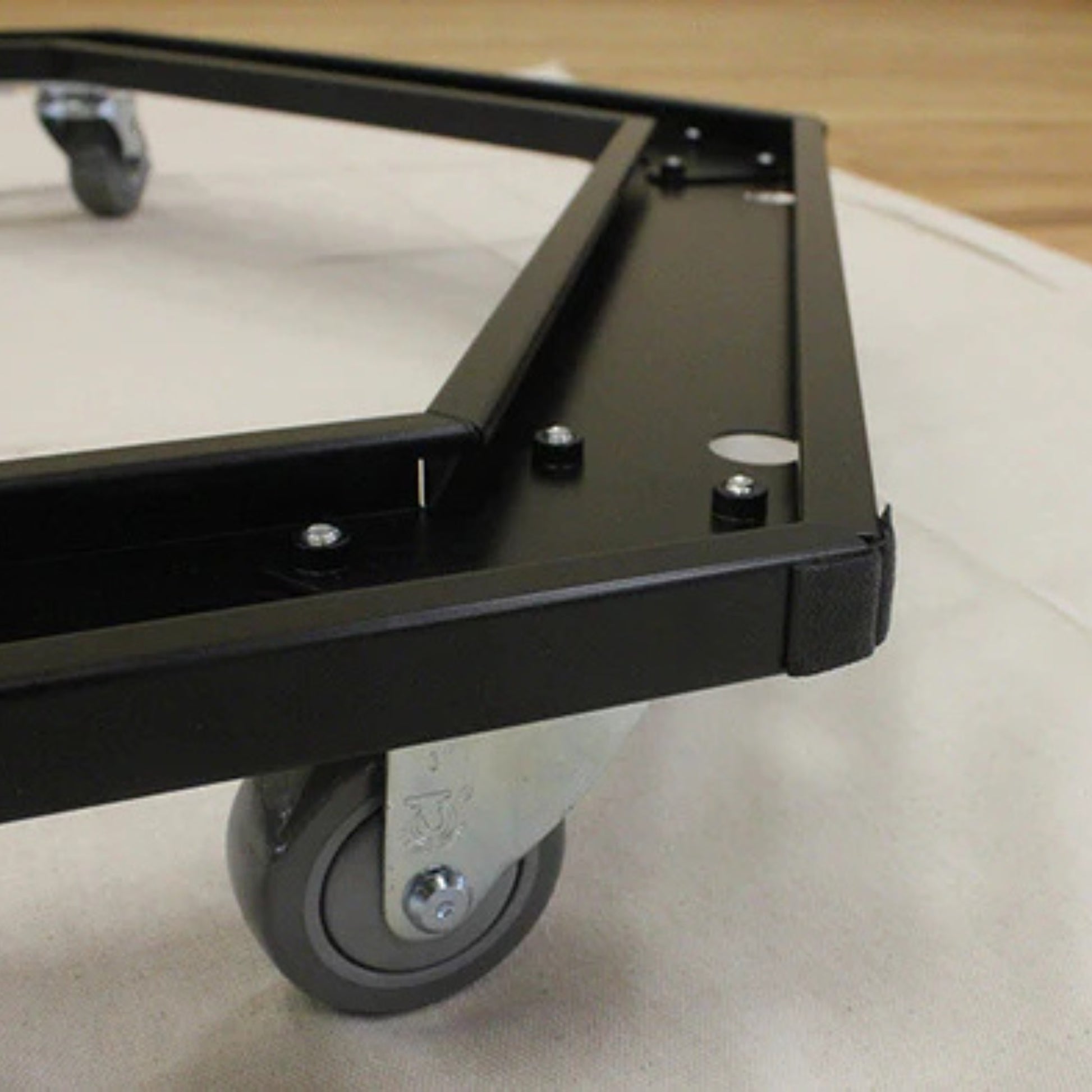Close-up of wheels on Jumpsport trampoline storage cart for portability