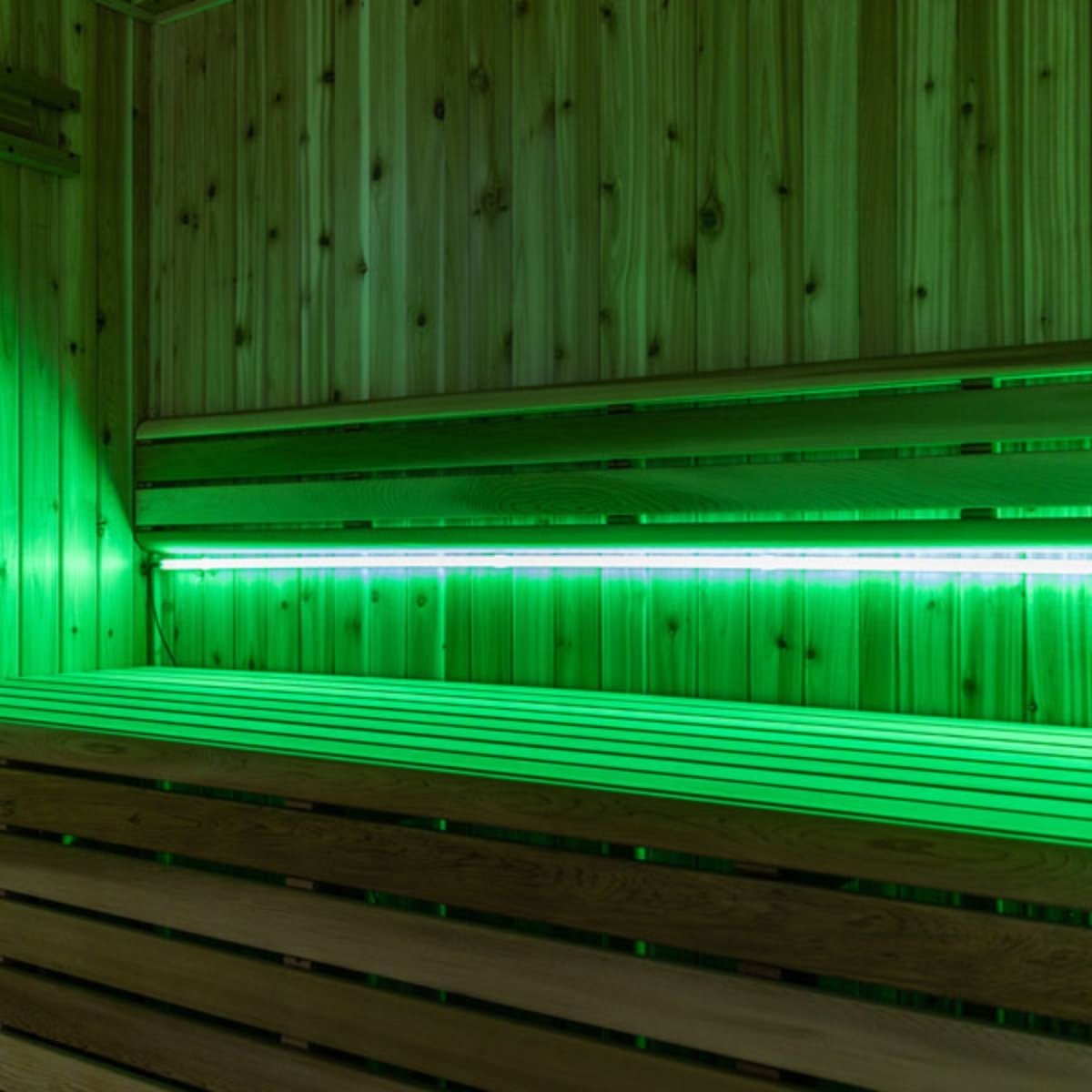 Leisurecraft 46-inch Lighting Set installed beneath cedar sauna bench with green LED lights that enhance the spa ambiance