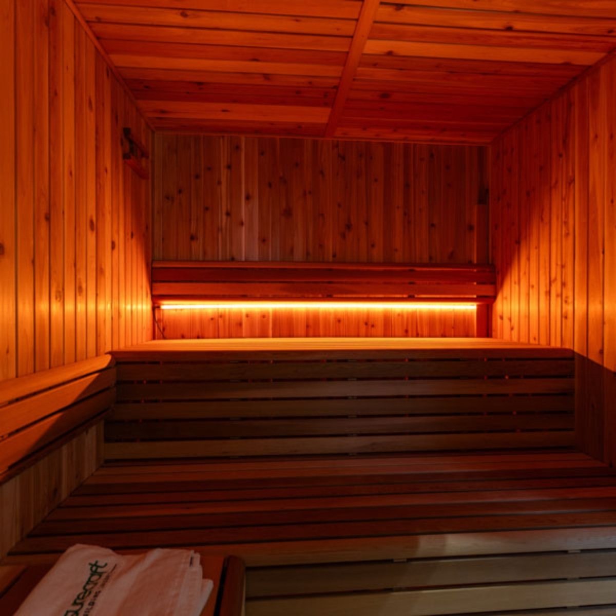 Leisurecraft 72-inch Lighting Set installed in a cedar sauna, featuring amber LED lighting that casts a warm, relaxing glow