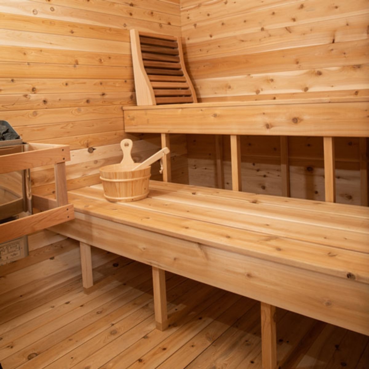 Leisurecraft CT Luna sauna interior with smooth Canadian cedar benches, wooden bucket, and backrest.
