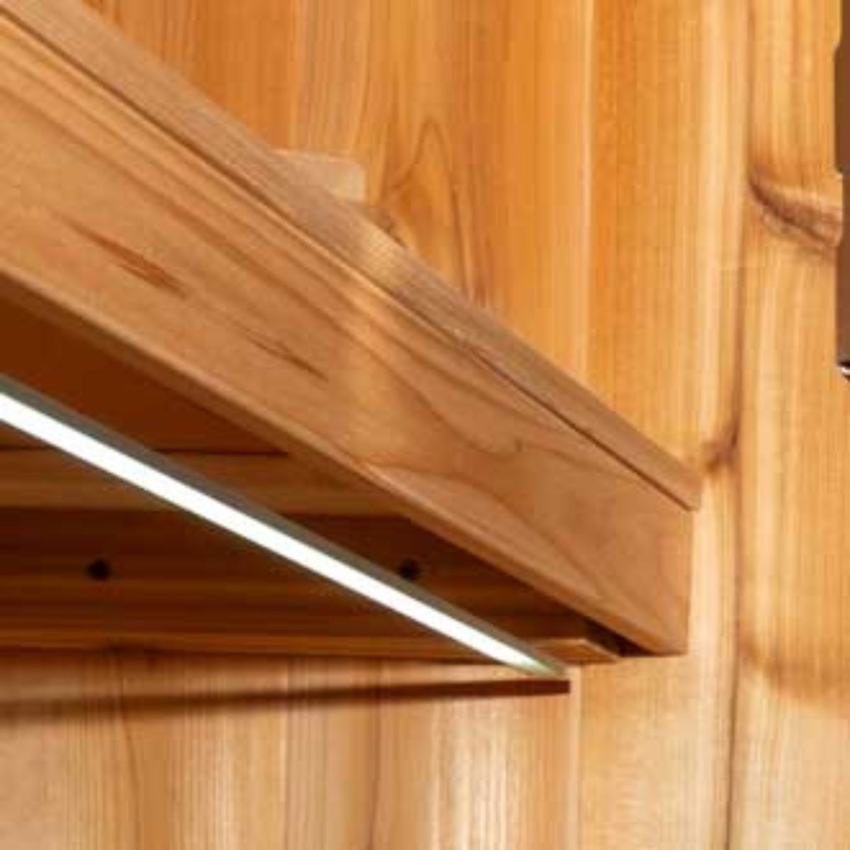 Leisurecraft double bench set inside sauna with under-bench lighting and smooth cedar seating