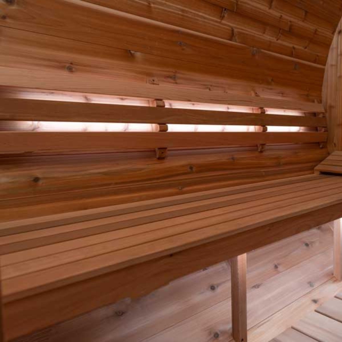 Leisurecraft single bench set inside cedar sauna with soft white lighting highlighting natural wood grain