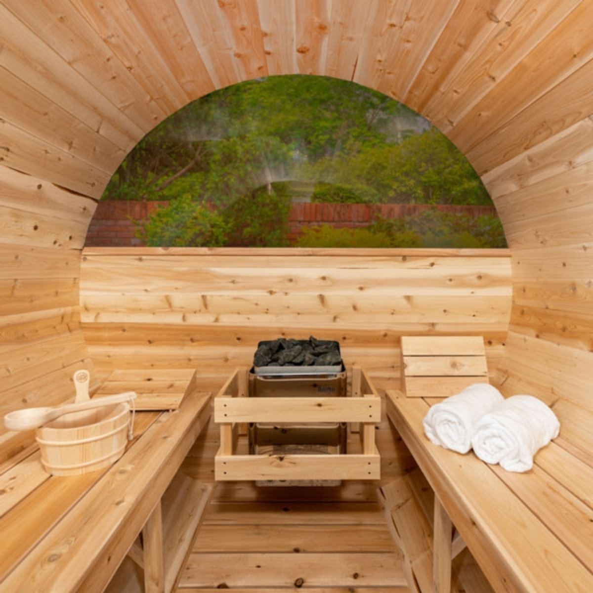 Leisurecraft Tranquility MP barrel sauna interior with cedar benches, heater, and towels.