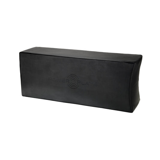 Power Plate soft foam exercise block in black with embossed logo, used for support and stability during workouts