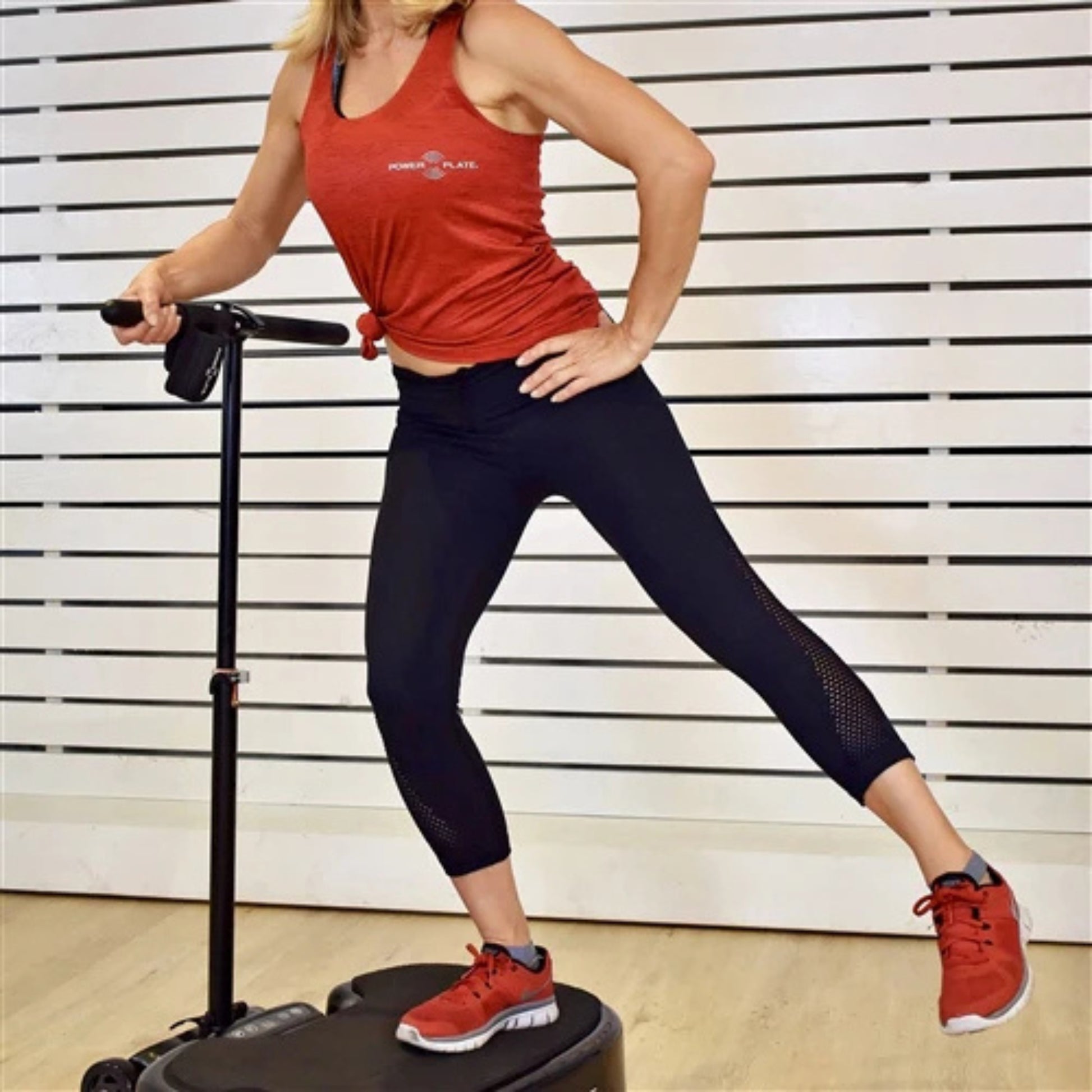 Demonstration of lateral leg exercise using Power Plate MOVE vibration platform to improve balance and stability
