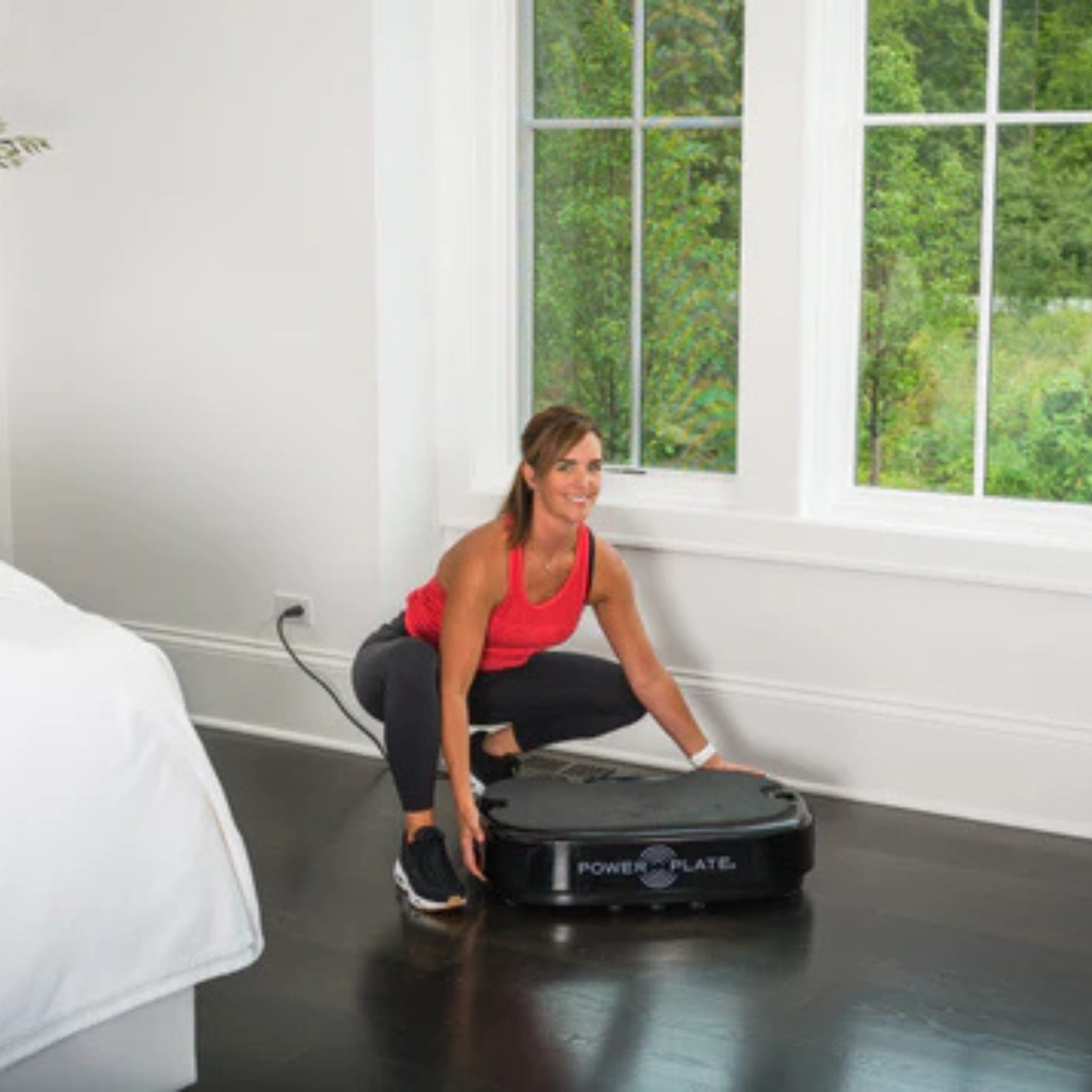 Man doing seated exercise on Power Plate vibration platform indoors