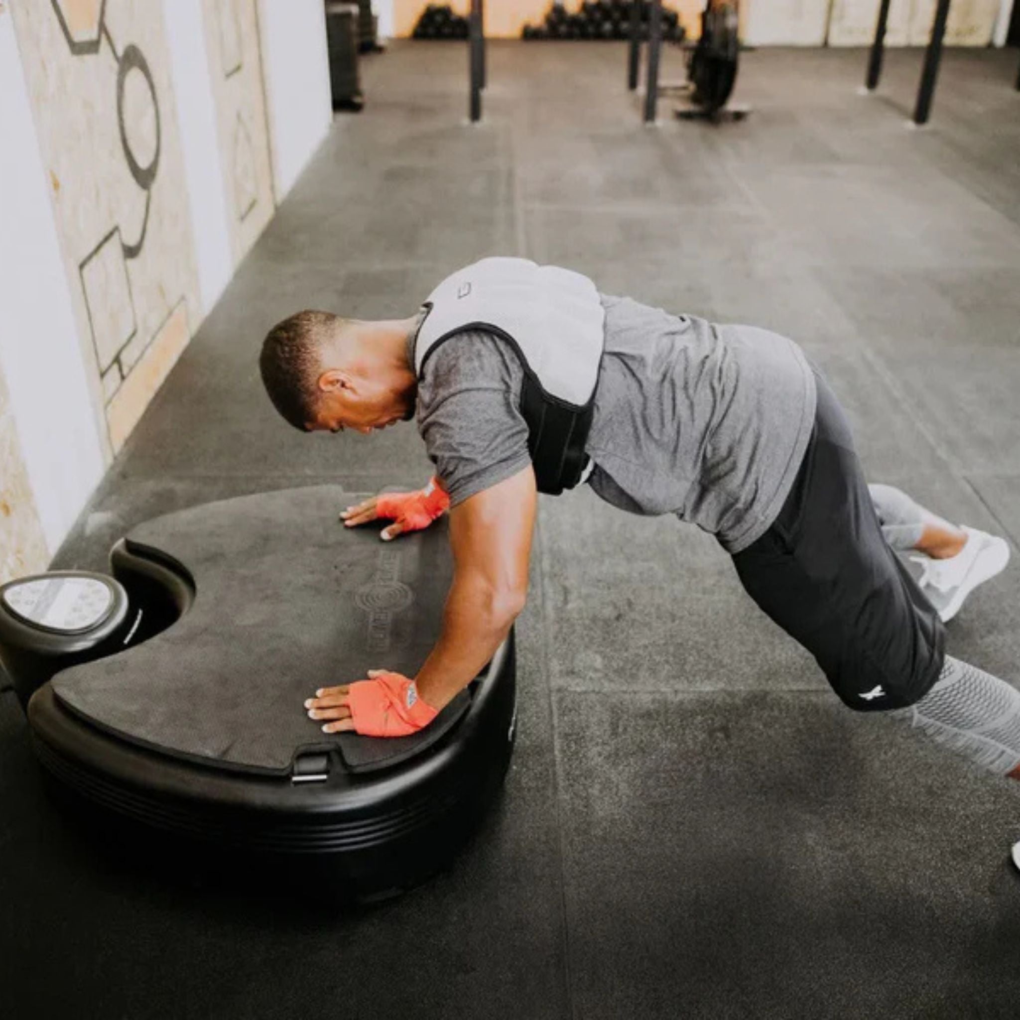 Athlete doing push-up exercise on Power Plate Pro vibration platform