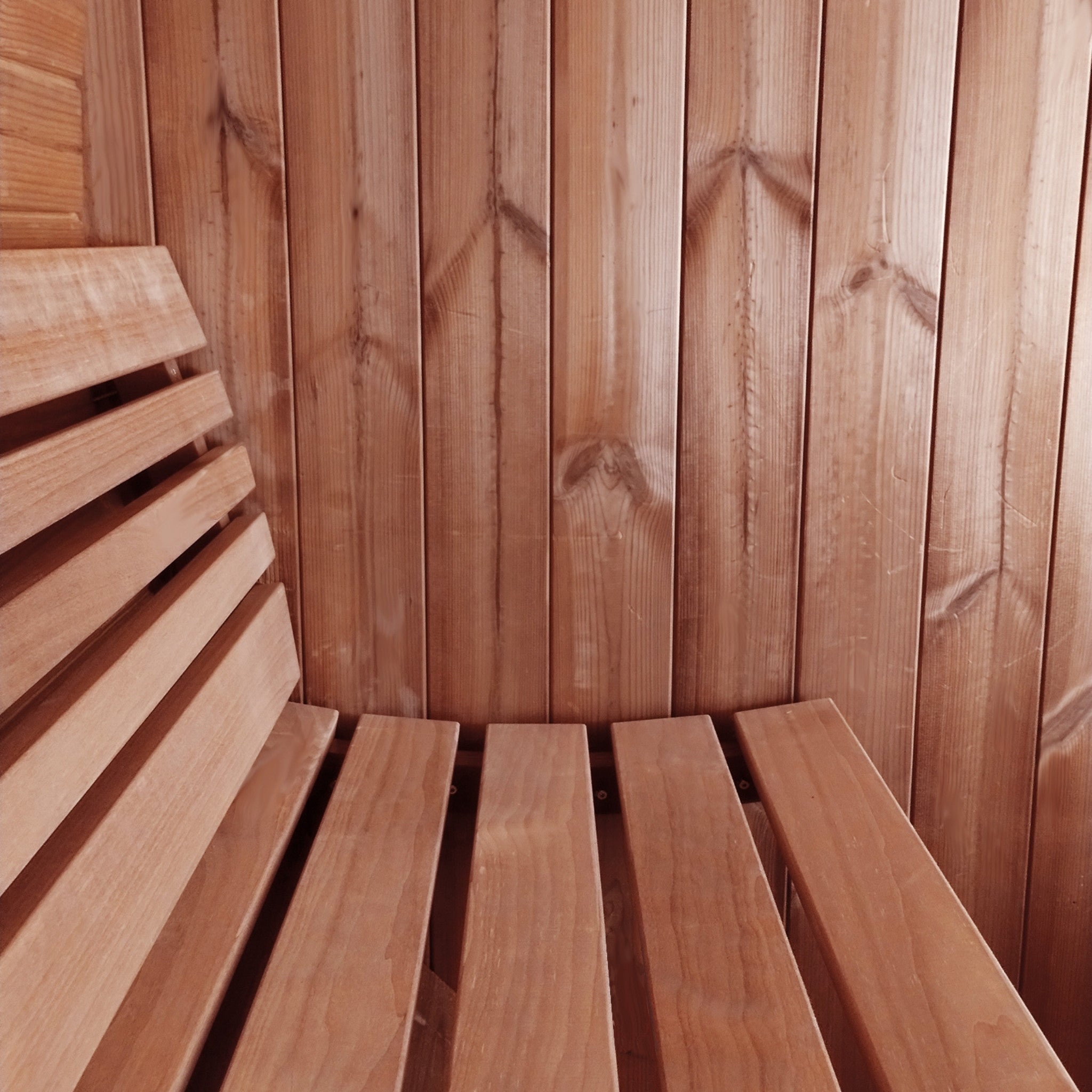 Interior of SaunaLife E7 barrel sauna featuring curved wooden benches and backrest