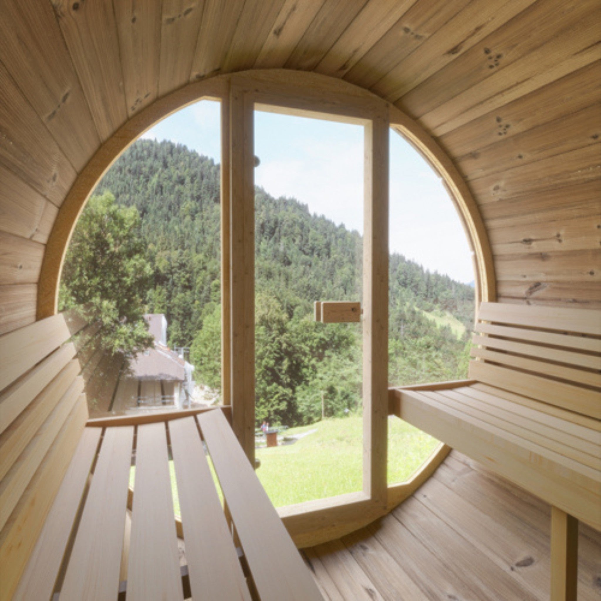 SaunaLife E7G interior with cedar benches and wide glass front showcasing landscape view.