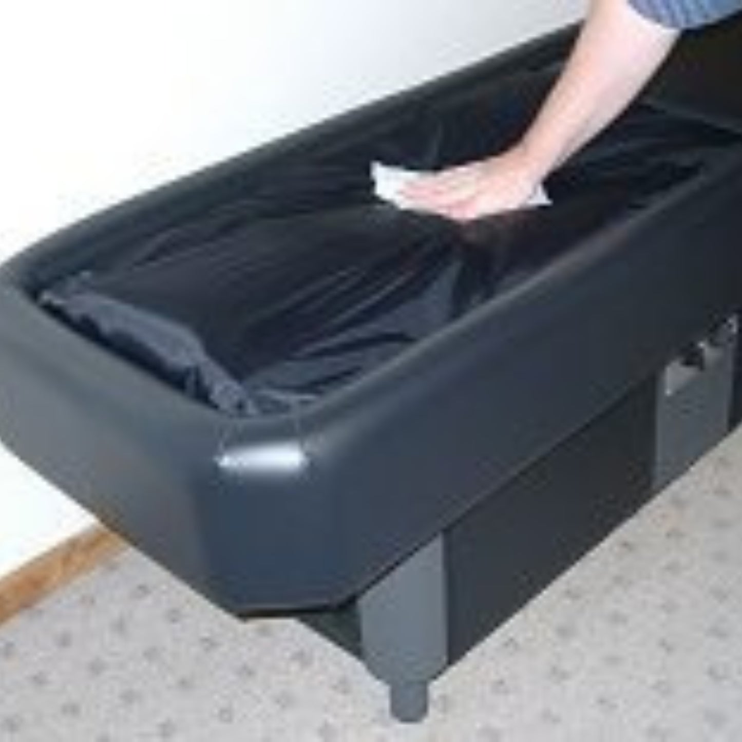 Foot pressing down inside Sidmar Hydrotable with replacement liner installed