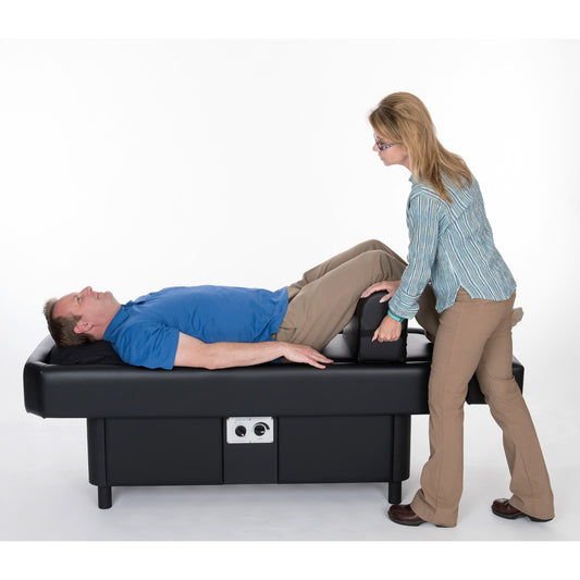 Practitioner assisting patient leg therapy on Sidmar Pro S10 Hydrotable in clinic