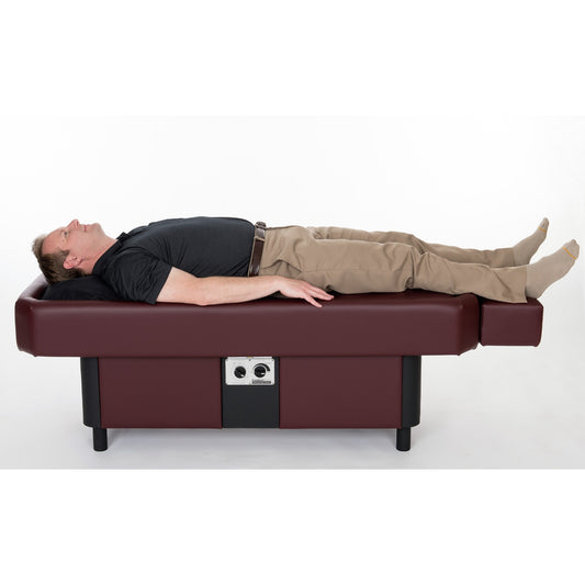 Patient lying down on Sidmar Pro S10 Hydrotable in black finish for therapy