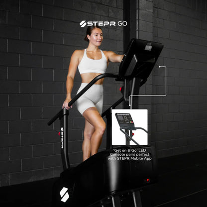 Woman using home stair climber fitness machine during standing workout