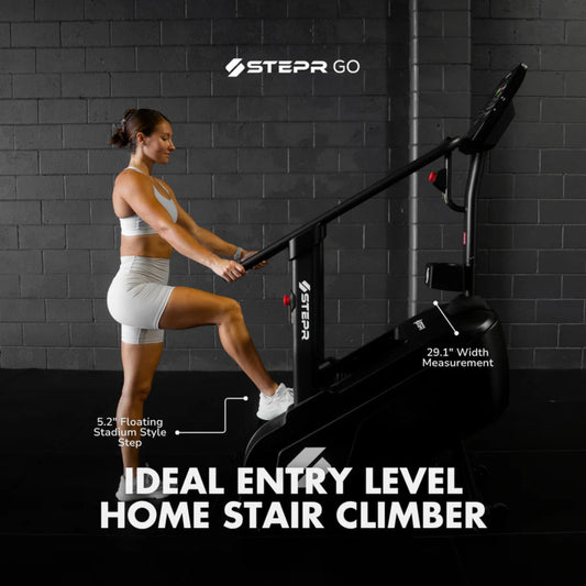 Woman exercising on home stair climber machine for lower body workout