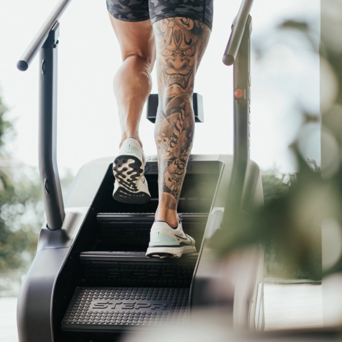Close-up of a person using the STEPR Classic stair climber for cardio and lower body strength training.