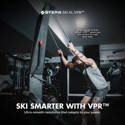 Man training shoulders on STEPR vertical climber machine in fitness studio