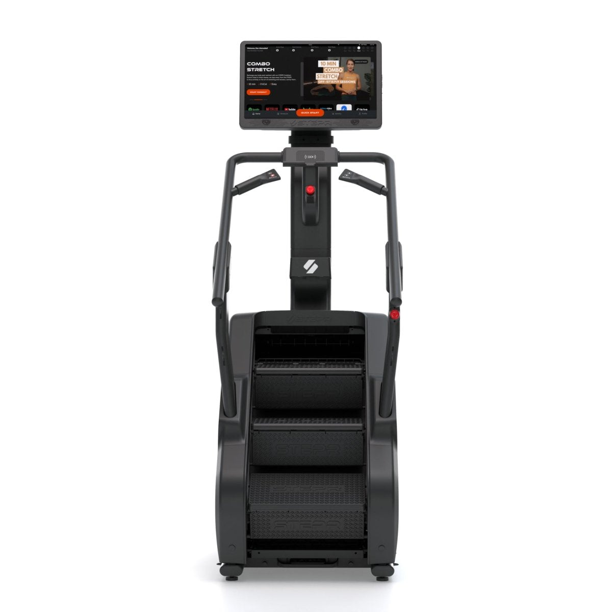Front view of STEPR XL stair climber with large HD touchscreen, wide steps, and black frame