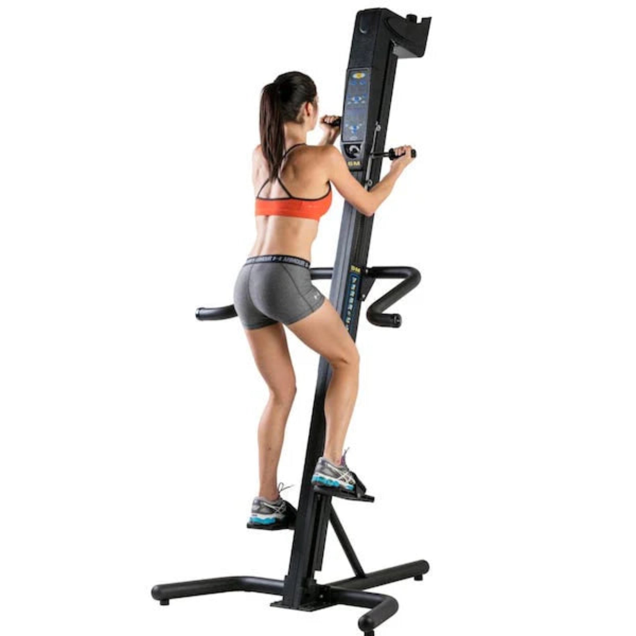Woman exercising on the VersaClimber SM-A Aerobic vertical climbing machine, performing a full-body zero-impact cardio workout in a gym setting.