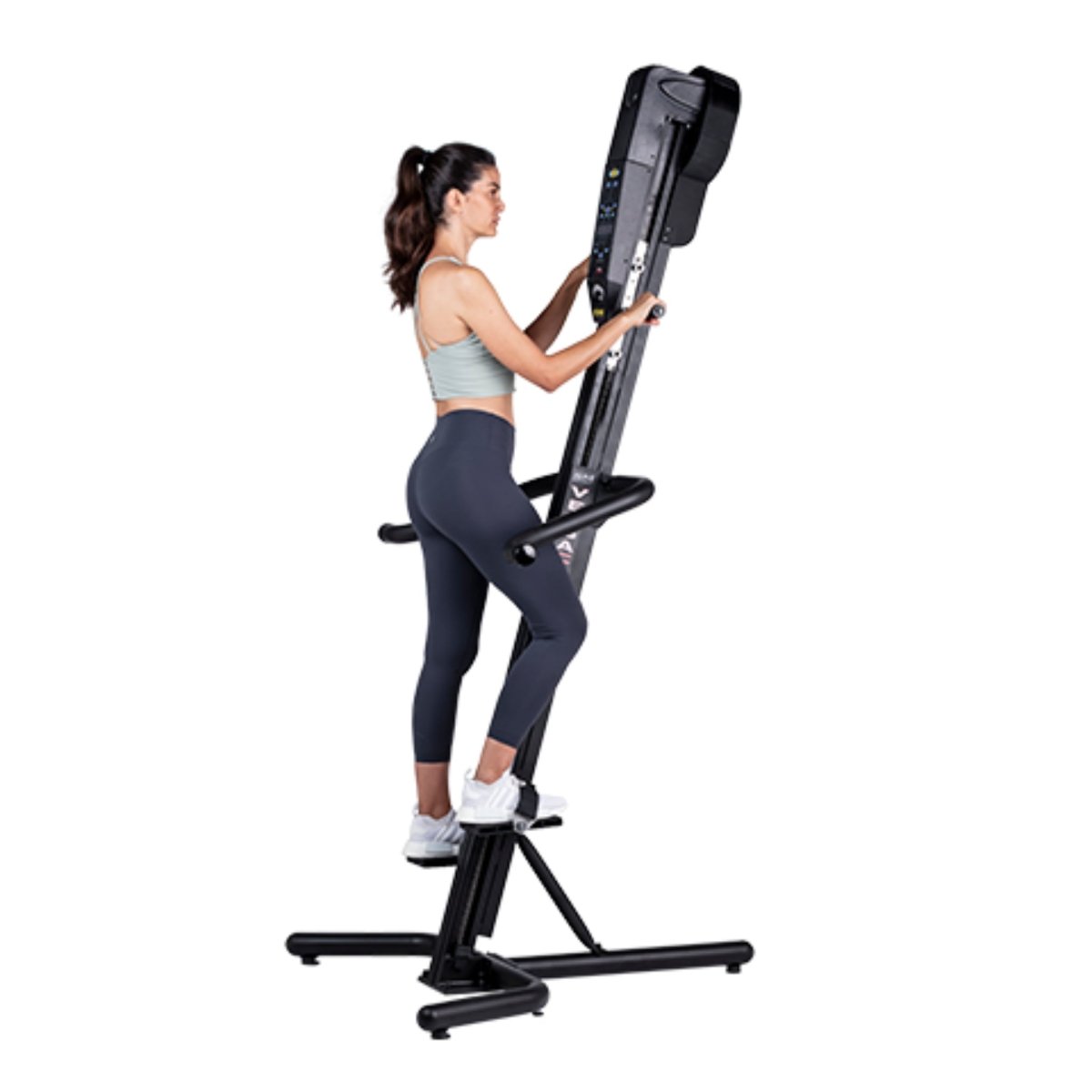 Woman exercising on the VersaClimber SM-M Magnetic in regular black finish, performing full-body zero-impact cardio and strength training.