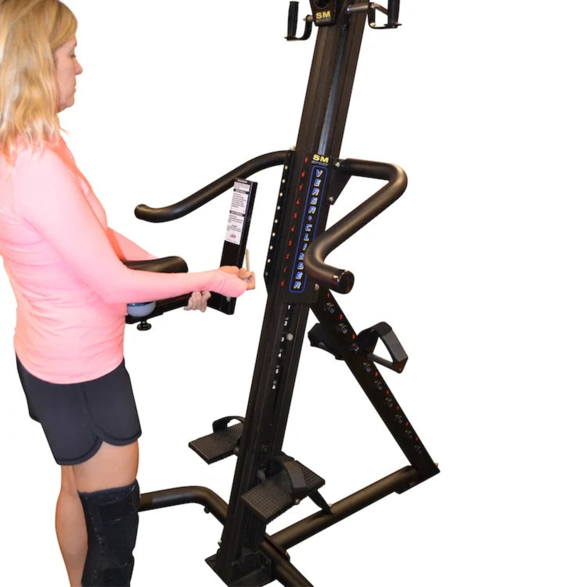 Woman using the VersaClimber SRM Sport Rehab Model for rehabilitation training, focusing on safe, low-impact cardio and full-body strength recovery.
