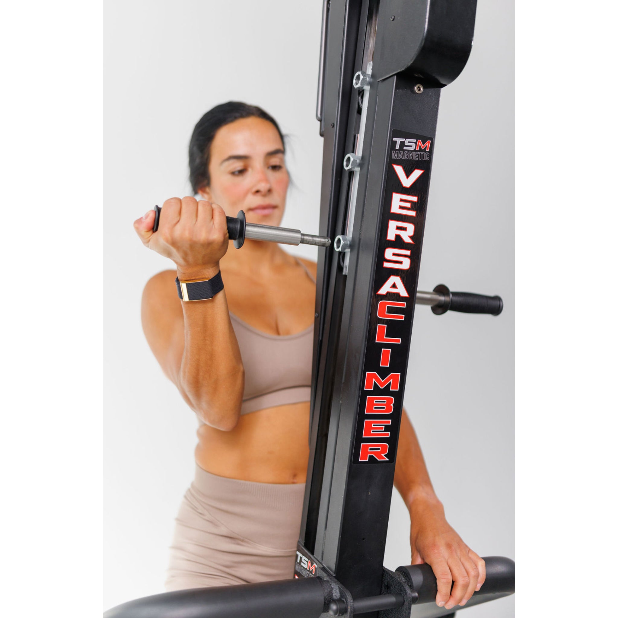 Woman exercising on the VersaClimber TS-M Magnetic in regular black, demonstrating full-body zero-impact cardio and strength training.