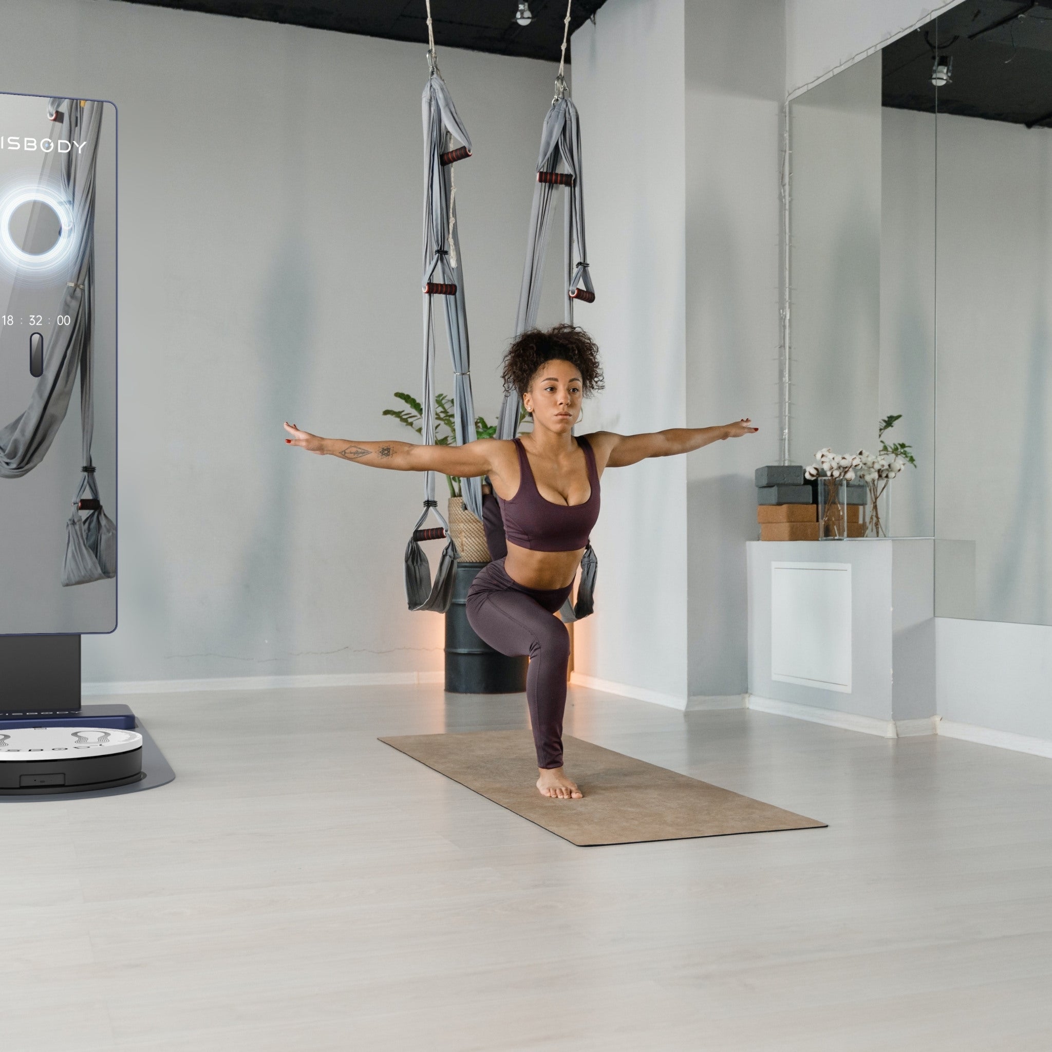 Woman exercising in a modern fitness studio with Visbody M30 3D body scanner for health and body composition analysis